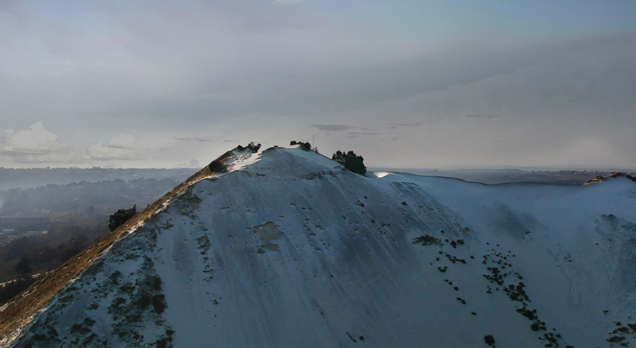 Mintails The top and ridge of a sandy mountain with the sky in the background