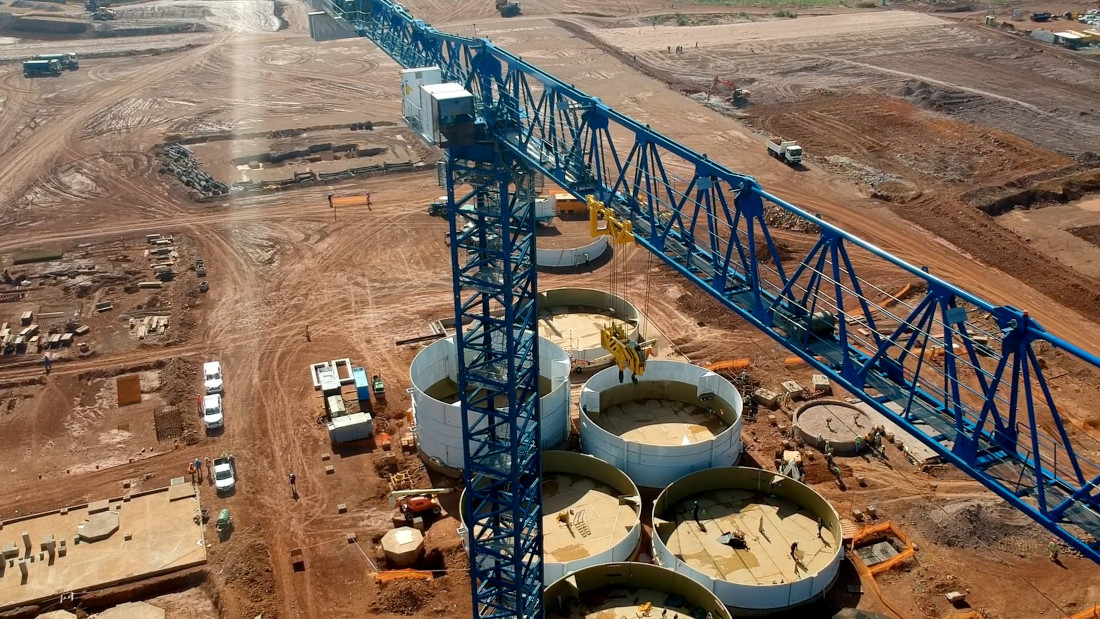 An aerial shot of a Pan African Resources mine construction site, depicting a blue crane and sand in the surrounds.