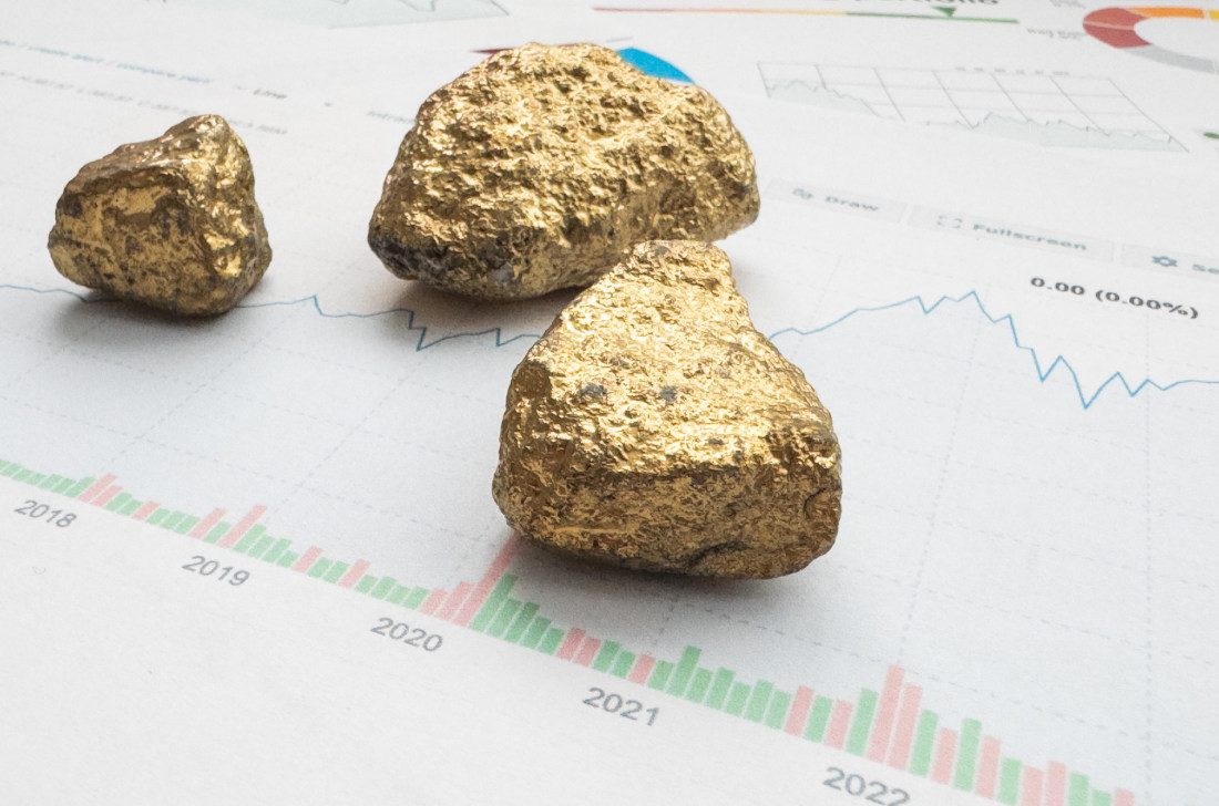 Three chunks of gold resting on a paper graph.