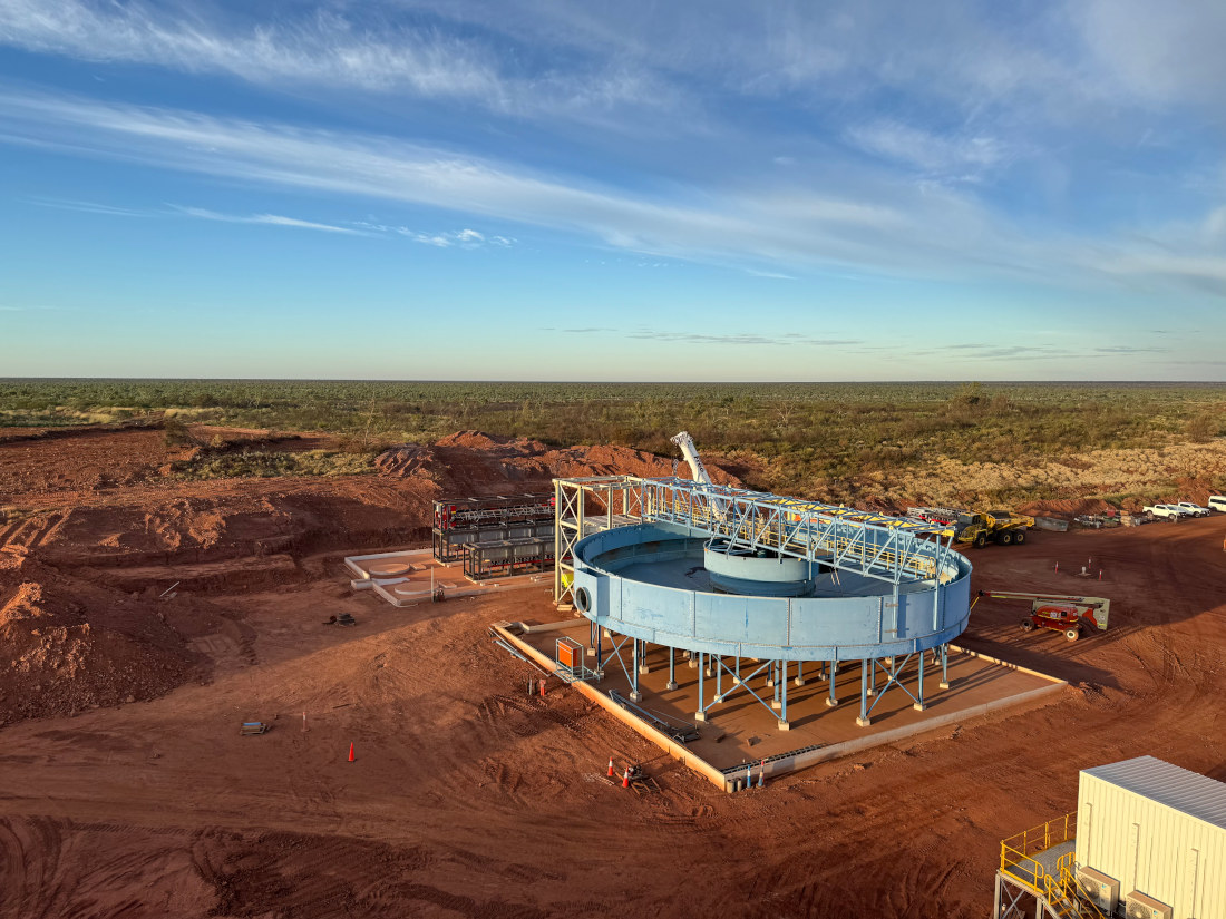Tennant Consolidated&nbsp;Gold Mining site under construction in Australia featuring a large blue thickener tank and red earth landscape around it.